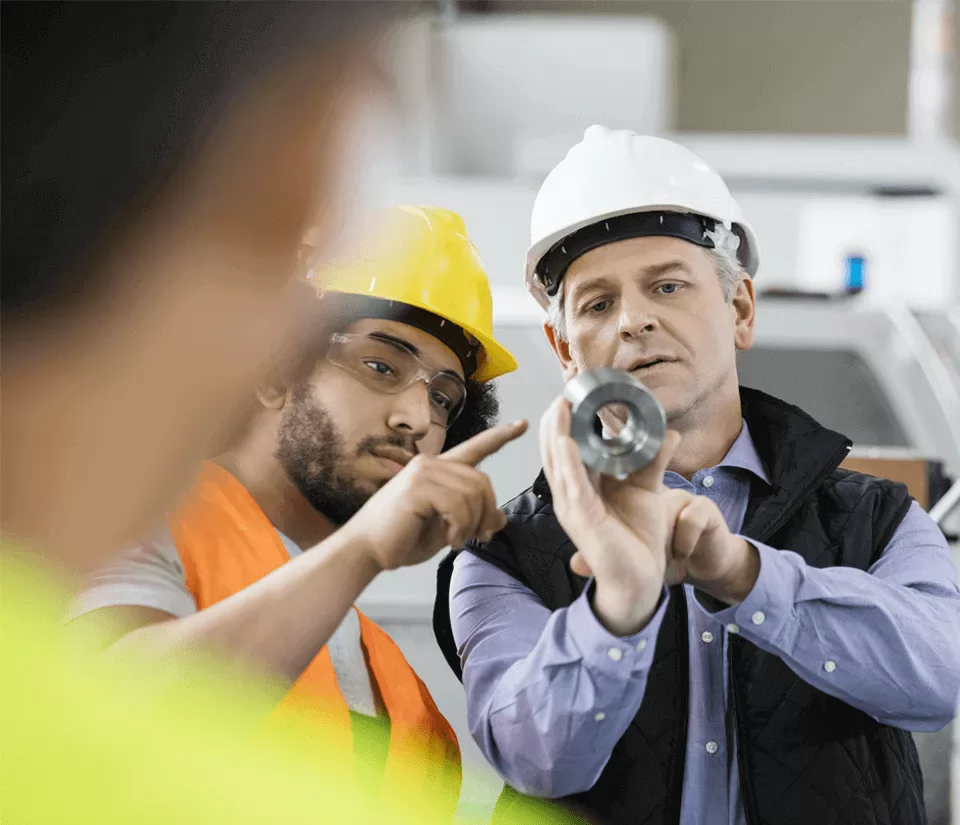 Operations Professionals discussing machining operation