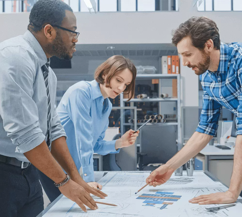 Engineers discussing manufacturing drawings